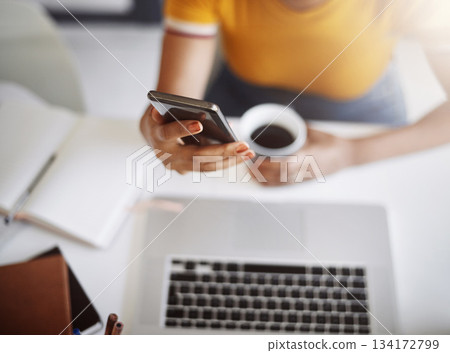 Hands, searching on smartphone with laptop, coffee and work in home office or shopping, browsing and mobile communication. Closeup, woman and social media, internet or online, work or ecommerce 134172799