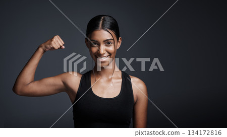 Portrait, smile and woman flexing bicep in studio isolated on a black background mockup space. Strong, happy and female athlete with muscle, arm strength and bodybuilder ready for fitness workout. Portrait, smile and woman flexing bicep in studio isolated on a black background mockup space. Strong, happy and female athlete with muscle, arm strength and bodybuilder ready for fitness workout. 134172816