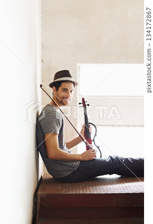 Portrait, musician and man with a violin, smile and training for a performance, sound or happiness at home. Face, male person of happy violinist with joy, creativity and instrument with entertainment 134172867