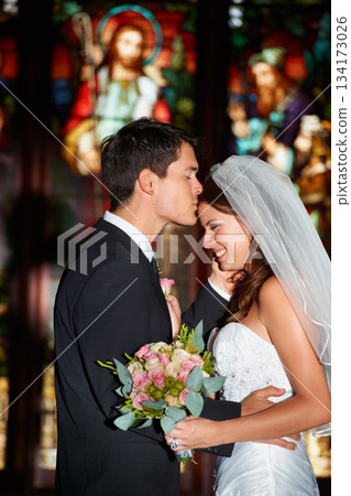 Wedding, marriage or ceremony with a bride and groom in a church or chapel for the tradition of vows. Married couple, love or trust with a man kissing a woman on the forehead as newlywed people Wedding, marriage or ceremony with a bride and groom in a church or chapel for the tradition of vows. Married couple, love or trust with a man kissing a woman on the forehead as newlywed people 134173026