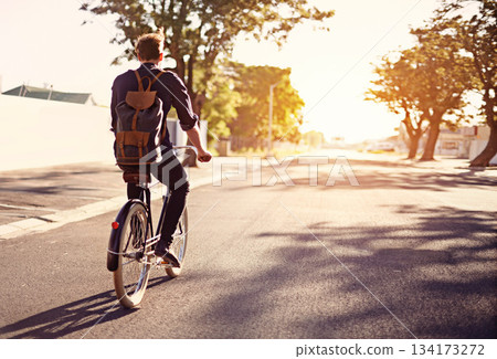 Bicycle, transport and back of man in road with lens flare for exercise, commute and cycling in morning. Travel, city and male cyclist on bike for eco friendly traveling, carbon footprint and journey 134173272