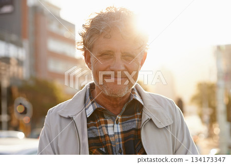 Mature, portrait and man in the city with lens flare and happiness from retirement. Sunshine, urban street and old male person face with freedom and a happy smile outdoor on holiday in New York 134173347