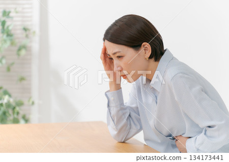 Woman touching her chin and neck Woman touching her chin and neck 134173441