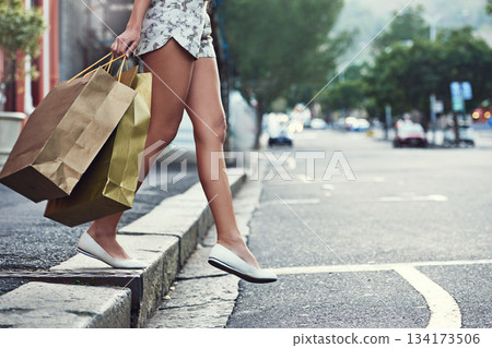Shopping bag, street and legs of woman walk, crossing road and travel in urban city after retail fashion spree. Sales product deal, store gift and chic female customer on commute journey with present Shopping bag, street and legs of woman walk, crossing road and travel in urban city after retail fashion spree. Sales product deal, store gift and chic female customer on commute journey with present 134173506