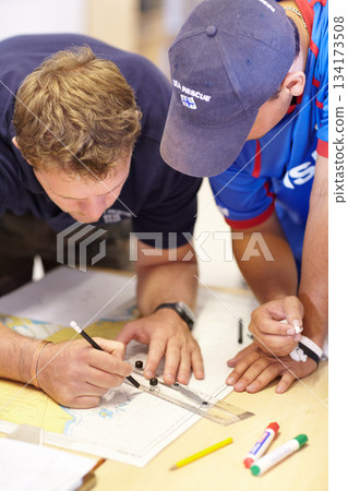Map, lifeguard teamwork and sea marine investigation with drawing and ruler on table. Sailing strategy, captain and boat worker with navigation paperwork with course planning and distance calculation Map, lifeguard teamwork and sea marine investigation with drawing and ruler on table. Sailing strategy, captain and boat worker with navigation paperwork with course planning and distance calculation 134173508