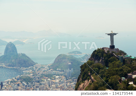 Brazil, monument and aerial of Christ the Redeemer on hill for tourism, sightseeing and travel destination. Traveling, Rio de Janeiro and drone view of statue, sculpture and city landmark on mountain Brazil, monument and aerial of Christ the Redeemer on hill for tourism, sightseeing and travel destination. Traveling, Rio de Janeiro and drone view of statue, sculpture and city landmark on mountain 134173544