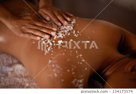 Salt, spa scrub and beauty therapist hands with woman customer at a hotel with massage. Exfoliate therapy, luxury and relax treatment of a female person back for skincare and wellness exfoliation 134173574