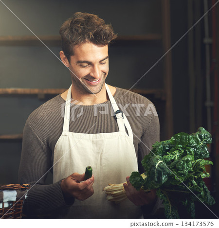 Food, happy man with vegetables and chef in kitchen in his home. Healthy or nutrition diet with spinach, ingredients or recipe and smiling male person with apron prepare green salad at his house 134173576