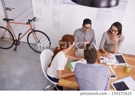 Team in conference room, creative people in meeting with collaboration, project planning and top view. Brainstorming, teamwork and strategy discussion in workplace, young men and women work together Team in conference room, creative people in meeting with collaboration, project planning and top view. Brainstorming, teamwork and strategy discussion in workplace, young men and women work together 134173625