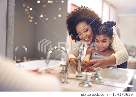 Water, cleaning and washing hands by mother and child in a bathroom for learning, hygiene and care. Basin, wash and hand protection by mom and girl together for prevention of bacteria, dirt and germs Water, cleaning and washing hands by mother and child in a bathroom for learning, hygiene and care. Basin, wash and hand protection by mom and girl together for prevention of bacteria, dirt and germs 134173639