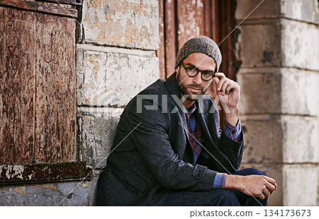Thinking, fashion and man outdoor, winter and relax with trendy clothes, eyewear and thoughtful. Male person, model or guy with glasses, wonder or ideas with stylish outfit, relax or ponder in a city 134173673