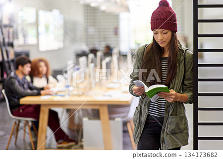 Woman, student in library reading book and study for exam or research for project on university campus. Education, learning and academic development with female person holding textbook for knowledge Woman, student in library reading book and study for exam or research for project on university campus. Education, learning and academic development with female person holding textbook for knowledge 134173682
