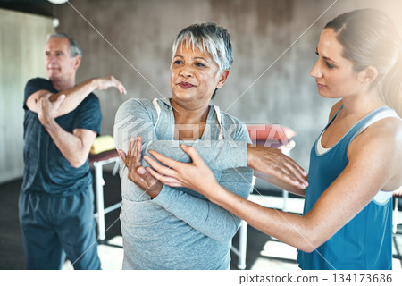 Stretching, physiotherapy and old woman with personal trainer for fitness, wellness or rehabilitation. Health, workout or retirement with senior patient and female trainer in gym for warm up training Stretching, physiotherapy and old woman with personal trainer for fitness, wellness or rehabilitation. Health, workout or retirement with senior patient and female trainer in gym for warm up training 134173686