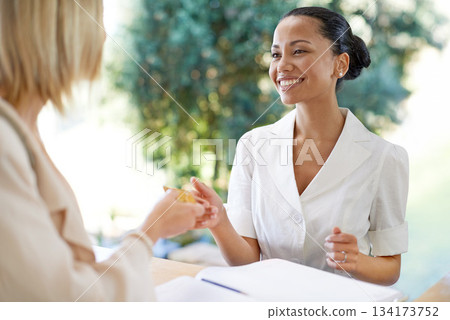 Sign in, card and woman paying with a receptionist for accommodation, lodge or hotel reservation. Happy, smile and friendly host doing payment and check in with female person by the reception counter Sign in, card and woman paying with a receptionist for accommodation, lodge or hotel reservation. Happy, smile and friendly host doing payment and check in with female person by the reception counter 134173752