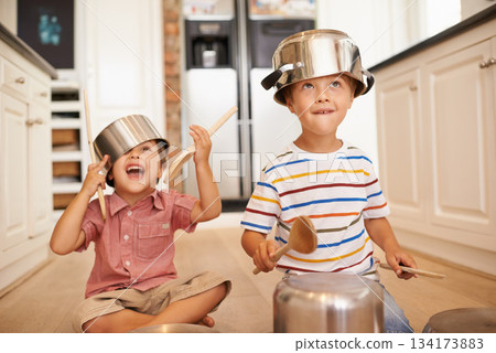 Smile, pots and playing with children in kitchen for imagination, fantasy and games. Bonding, siblings and happy with kids and kitchenware on floor of family home for music, noise and happiness Smile, pots and playing with children in kitchen for imagination, fantasy and games. Bonding, siblings and happy with kids and kitchenware on floor of family home for music, noise and happiness 134173883
