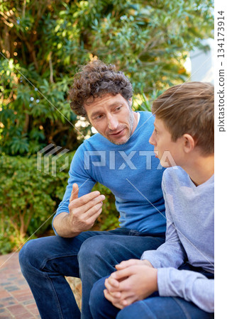 Family, father has talk with son in backyard, bonding with love and care, communication and relationship. Man with boy at home, relax in nature with conversation and spending quality time outdoor Family, father has talk with son in backyard, bonding with love and care, communication and relationship. Man with boy at home, relax in nature with conversation and spending quality time outdoor 134173914