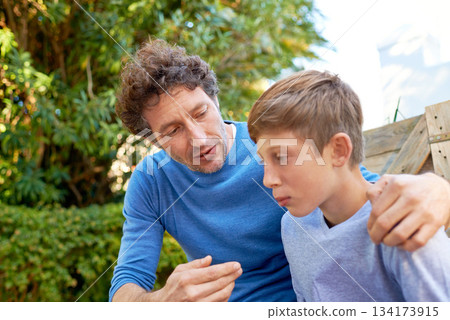Family, father talking with son in backyard, bonding with love and care, communication and relationship. Man with sad teen boy, help with advice at home and outdoor together with trust and support Family, father talking with son in backyard, bonding with love and care, communication and relationship. Man with sad teen boy, help with advice at home and outdoor together with trust and support 134173915