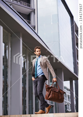 Professional, walking and businessman travel in the city in suit working at the office with hands. Young, man and corporate in front of urban buildings as a worker commutes to a startup company. Professional, walking and businessman travel in the city in suit working at the office with hands. Young, man and corporate in front of urban buildings as a worker commutes to a startup company. 134173937