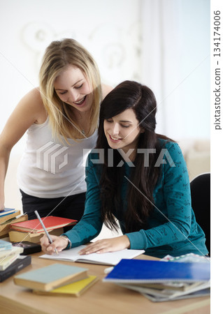 Education, student and women writing in a book for homework, essay and assignment research in their home. Remote, learning and girl university friends help with notes, idea and creative brainstorming Education, student and women writing in a book for homework, essay and assignment research in their home. Remote, learning and girl university friends help with notes, idea and creative brainstorming 134174006