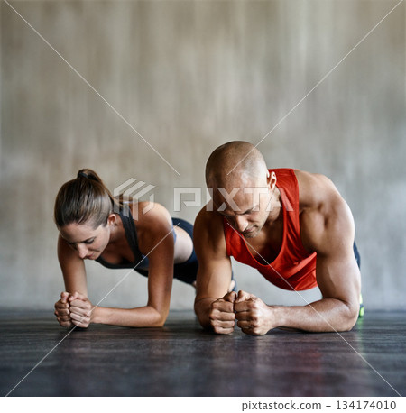 Gym floor, focus and team doing plank exercise, health performance or core strength building for bodybuilding. Training, teamwork and athlete man, woman or people concentrate on fitness workout Gym floor, focus and team doing plank exercise, health performance or core strength building for bodybuilding. Training, teamwork and athlete man, woman or people concentrate on fitness workout 134174010