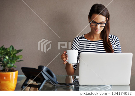 Laptop, coffee and happy business woman in office smile, satisfied and content against a wall background. Tea, research and female worker online for planning, browsing and creative inspiration Laptop, coffee and happy business woman in office smile, satisfied and content against a wall background. Tea, research and female worker online for planning, browsing and creative inspiration 134174052