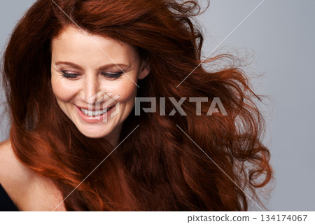 Hair, salon and face of woman in studio for keratin treatment, wellness and haircare on gray background. Beauty, hairdresser mockup and happy female model with red, healthy and natural hairstyle Hair, salon and face of woman in studio for keratin treatment, wellness and haircare on gray background. Beauty, hairdresser mockup and happy female model with red, healthy and natural hairstyle 134174067