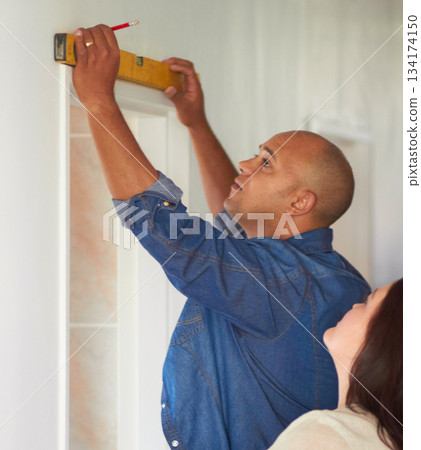 Spirit meter, man contractor and measure for maintenance, home improvement with wife. Construction, couple and male person with pencil drawing on a wall for level measuring of handyman and line Spirit meter, man contractor and measure for maintenance, home improvement with wife. Construction, couple and male person with pencil drawing on a wall for level measuring of handyman and line 134174150