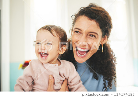 Mother, laughing baby and a happiness in a family home while together for love, support and care. Woman or mom and girl child laugh for funny or comic joke for quality time, bonding and to relax Mother, laughing baby and a happiness in a family home while together for love, support and care. Woman or mom and girl child laugh for funny or comic joke for quality time, bonding and to relax 134174185