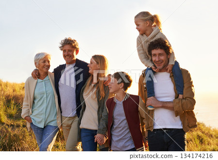 Love, countryside and family bonding, smile and quality time with happiness, walking and relax. Grandparents, mother and happy father carry daughter, siblings and loving outdoor, break and adventure Love, countryside and family bonding, smile and quality time with happiness, walking and relax. Grandparents, mother and happy father carry daughter, siblings and loving outdoor, break and adventure 134174216