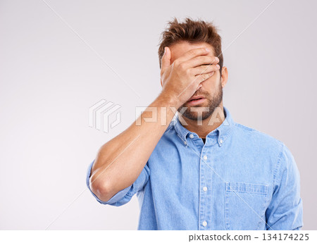 Mockup, covering eyes and man with regret, mistake and guy against a grey studio background. Male person, model or human with hand on face, frustrated and problem with an issue, upset or disappointed 134174225