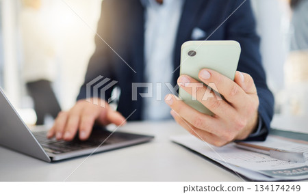 Phone, closeup and laptop with hands of man in office for research, planning and networking. Technology, digital and communication with male employee for contact, online connection and email Phone, closeup and laptop with hands of man in office for research, planning and networking. Technology, digital and communication with male employee for contact, online connection and email 134174249