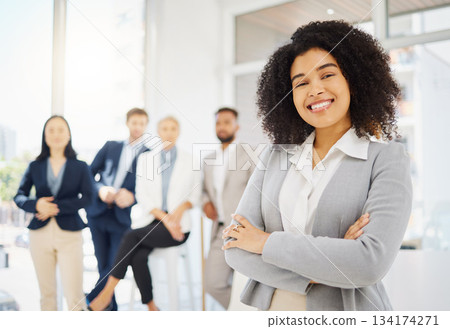 Business, happy and portrait of African woman in office with confidence, pride and crossed arms. Corporate, professional and female worker smile with team for success, company mission and leadership 134174271