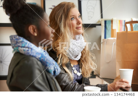 Shopping, customer and friends in a store with coffee and bags feeling happy to buy retail products or service. Girls, diversity and women or people in happiness together in a fashion shop Shopping, customer and friends in a store with coffee and bags feeling happy to buy retail products or service. Girls, diversity and women or people in happiness together in a fashion shop 134174468