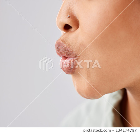 Pout, lips and woman face whistle with her mouth or kiss with lipstick or gloss isolated in a white studio background. Flirting, care and natural lip of a female person showing love, care and romance 134174787