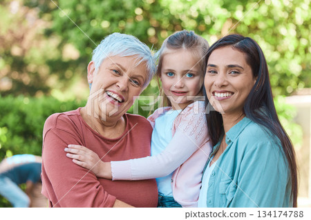 Family, women and portrait in a garden with love, hug and happy while bonding outdoors. Face, smile and girl with mother and grandmother in a park, embrace and enjoying the weekend outside together 134174788