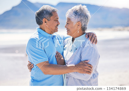 Senior couple, hug and sea vacation outdoor with love and romance in nature. Ocean, elderly and old woman and man together on summer holiday by the sea feeling happiness and relax on a beach 134174869