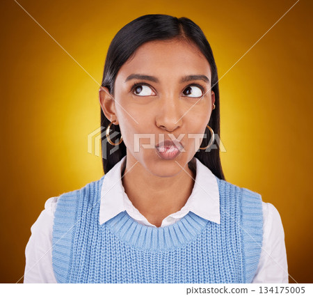 Thinking, idea and woman in studio unsure, pensive and wondering on gradient yellow background. Contemplating, doubt and puzzled Indian lady with decision, choice or emoji while posing isolated 134175005