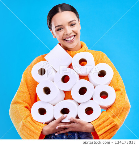 Toilet paper, young woman and portrait with happiness and smile in a studio. Isolated, blue background and happy female person and youth model with tissue rolls stock and gen z fashion smiling Toilet paper, young woman and portrait with happiness and smile in a studio. Isolated, blue background and happy female person and youth model with tissue rolls stock and gen z fashion smiling 134175035