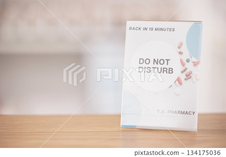 Employee break, sign and pharmacy poster in a medical shop and clinic with mockup. Wellness, doctor and advertising placard showing do not disturb message for customer on a billboard with mock up 134175036