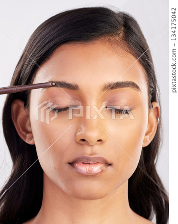 Woman, face and eyebrow pencil with beauty, makeup and eyes closed for cosmetics product on studio background. Microblading, facial or skin grooming for young Indian female, eyeliner or cosmetic care Woman, face and eyebrow pencil with beauty, makeup and eyes closed for cosmetics product on studio background. Microblading, facial or skin grooming for young Indian female, eyeliner or cosmetic care 134175042