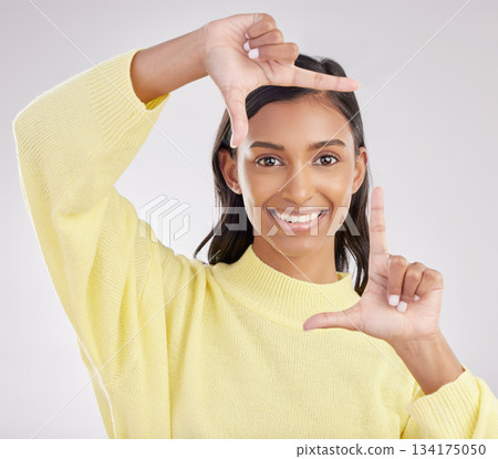 Finger frame, portrait and happy woman in white background, studio or review profile picture. Face, indian female and hands of model, border perspective and selfie of creativity, smile or photography Finger frame, portrait and happy woman in white background, studio or review profile picture. Face, indian female and hands of model, border perspective and selfie of creativity, smile or photography 134175050