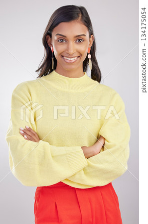 Woman with smile in portrait, arms crossed with confidence and success isolated on studio background. Young, professional and confident Indian female with positive ambition, happiness and empowerment 134175054