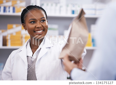 Black woman, medicine or pharmacist hands customer a bag in drugstore with healthcare prescription receipt. Shopping or happy African doctor giving patient pills or package in medical retail service Black woman, medicine or pharmacist hands customer a bag in drugstore with healthcare prescription receipt. Shopping or happy African doctor giving patient pills or package in medical retail service 134175127