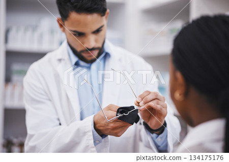 Vision help, cleaner or glasses lens for man in pharmacist work helping a customer at pharmacy. Shop, eyewear clean and healthcare worker in a wellness and retail store working at a clinic with frame 134175176