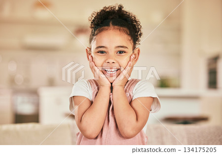 Girl child, surprise smile and portrait in home living with happiness, youth and childhood. Happy female kid, excited and hands on face with wow in lounge, house or apartment with blurred background 134175205