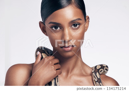 Beauty, skincare and portrait of woman with snake on neck in studio for art aesthetic with exotic zoo animal. Face, danger and creative style, asian model dangerous pet python on white background. 134175214