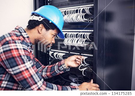 Electrician, engineering and black man with circuit board for inspection, maintenance and repair. Construction, electricity and male worker, handyman and mechanic with system, cable server and switch Electrician, engineering and black man with circuit board for inspection, maintenance and repair. Construction, electricity and male worker, handyman and mechanic with system, cable server and switch 134175285