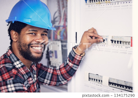 Black man in portrait, electrician and electricity fuse box, check power supply with maintenance on main circuit breaker. Engineer, technician and male worker with smile, handyman and electrical fix Black man in portrait, electrician and electricity fuse box, check power supply with maintenance on main circuit breaker. Engineer, technician and male worker with smile, handyman and electrical fix 134175290