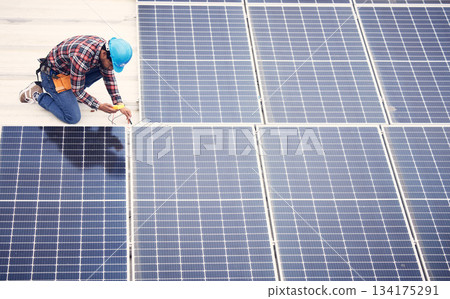 Black man, solar panel installation and renewable energy, sustainability and eco friendly technology. Maintenance, male engineer and infrastructure, electricity and top view with energy saving 134175291