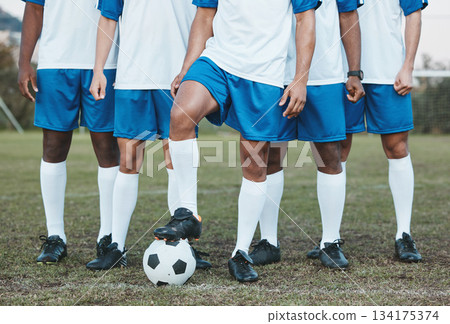 Soccer ball, sports group and feet of a team on a field to start fitness training or game outdoor. Football player, club and legs of athlete men together for sport competition, exercise and challenge Soccer ball, sports group and feet of a team on a field to start fitness training or game outdoor. Football player, club and legs of athlete men together for sport competition, exercise and challenge 134175374